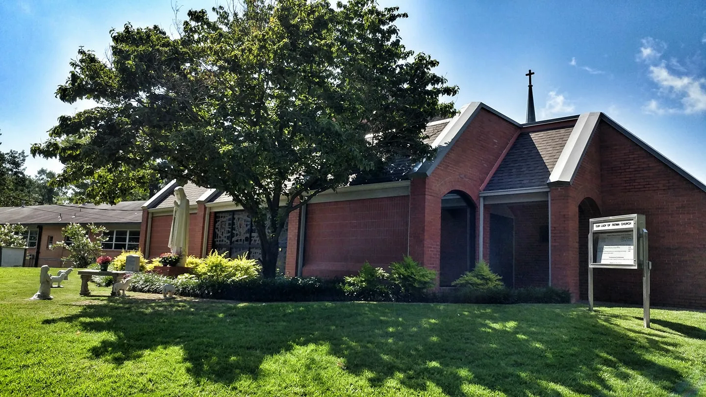 Brick Catholic church with a statue of Mary out front, Benton, Arkansas