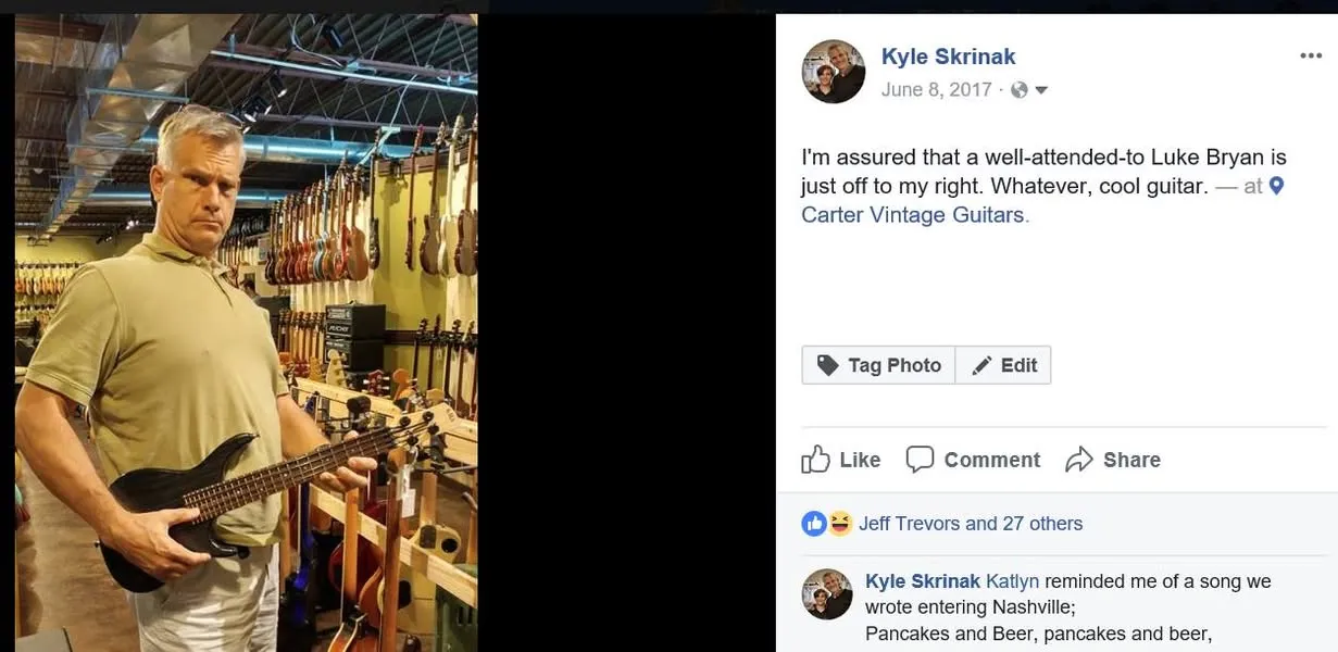 Kyle at Carter Vintage Guitars, examining a guitar surrounded by instruments